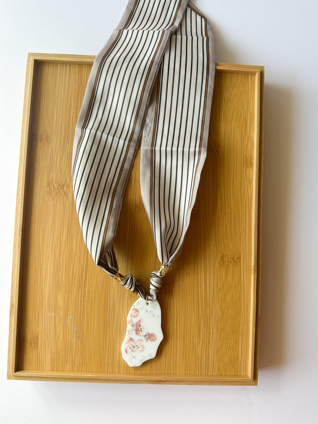 Pale Floral Piece on Striped Scarf Necklace